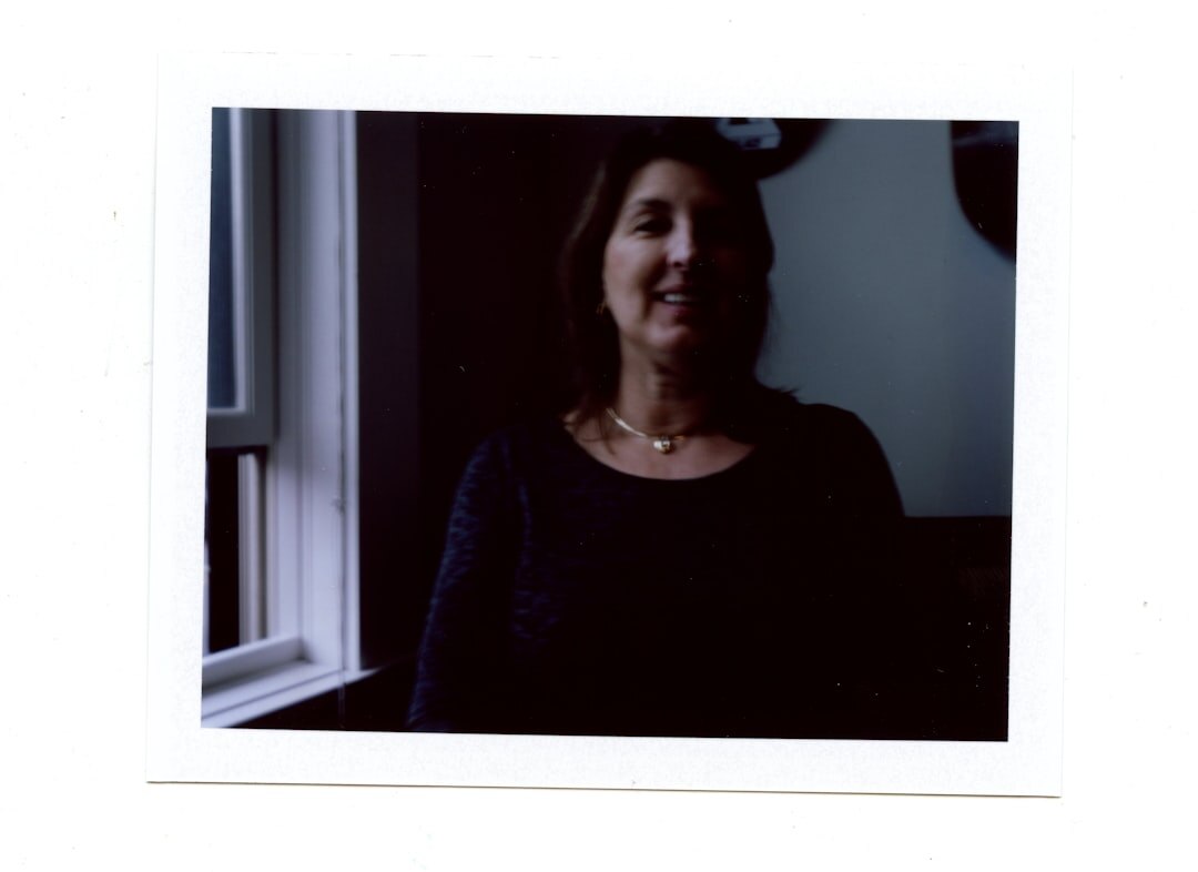 Studio portrait of a Croatian mystery novelist in his fifties, wearing a dark sweater, sitting in a home study