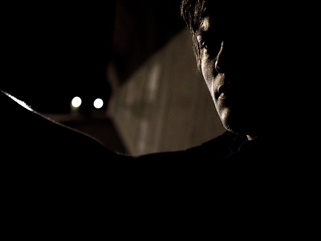 person reading thriller book at night